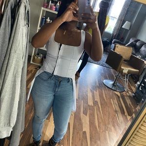 White zip up top with black stitching